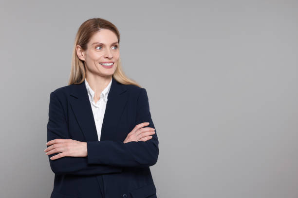 istock Happy real estate agent on grey background. Space for text 1708943725
