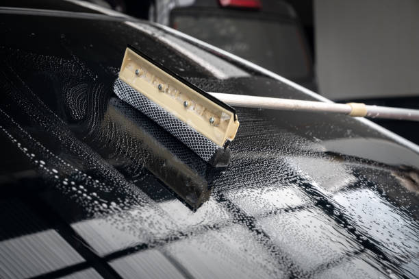 istock Someone using a glass wiper for cleaning a car windshield. 1708952225