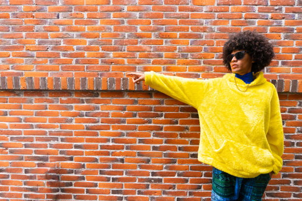istock fashionable afro mexican man with cool attitude is pointing copy space 1708953809