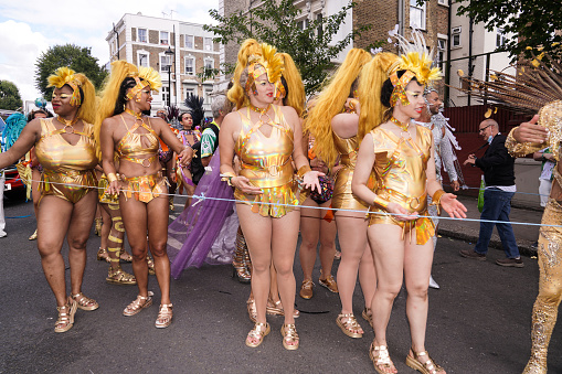 Editorial photo information: Notting Hill, London, England, United Kingdom - August 28, 2023\n\nRevellers take part in the Notting Hill Carnival.\nThe Notting Hill Carnival is an annual Caribbean Carnival event that has taken place in London since 1966 on the streets of the Notting Hill area of Kensington, over the August Bank Holiday weekend.