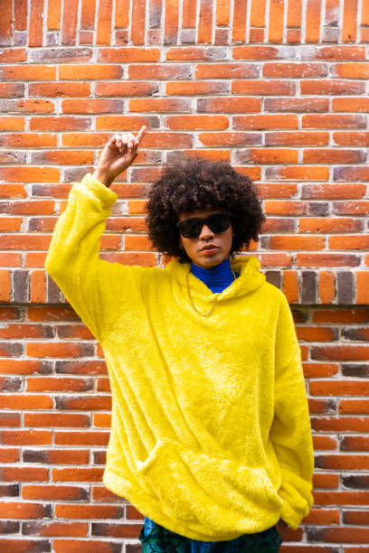 istock fashionable afro mexican man with cool attitude is pointing copy space in vertical 1708956485
