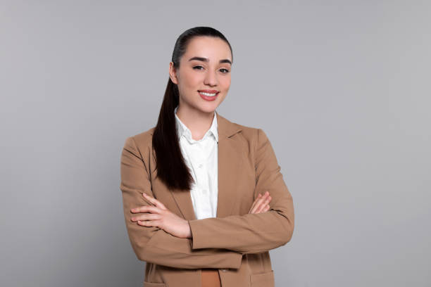 istock Happy real estate agent on grey background 1708959273