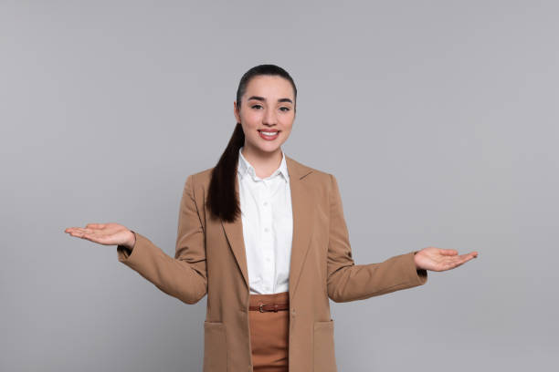 istock Happy real estate agent on grey background 1708959794