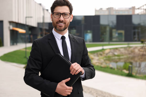 istock Real estate agent with leather portfolio outdoors. Space for text 1708972663
