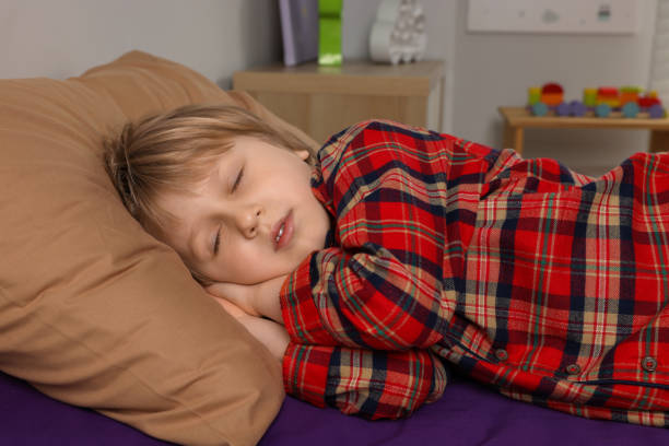 istock Little boy snoring while sleeping in bed at home 1708984698