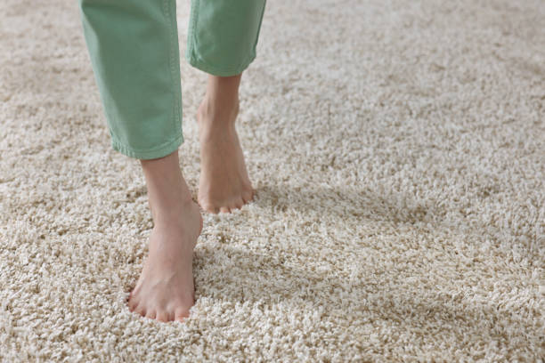 istock Woman walking on soft beige carpet at home, closeup. Space for text 1708993608