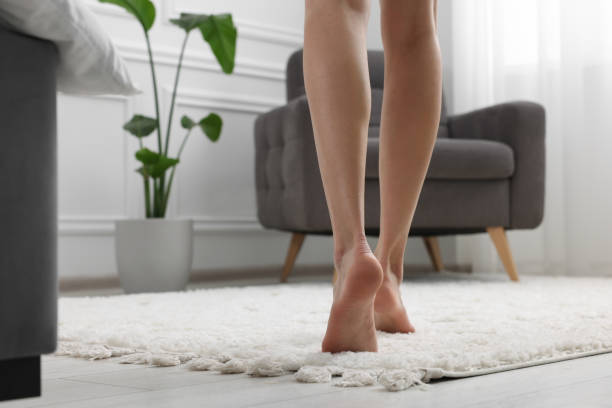 istock Woman walking on soft white carpet at home, closeup. Space for text 1708994640