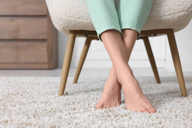 istock Woman on soft light brown carpet at home, closeup. Space for text 1708995167