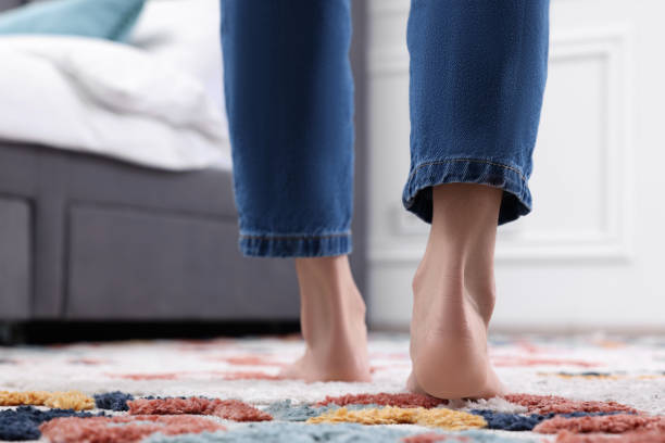 istock Woman walking on carpet with pattern at home, closeup 1708996781