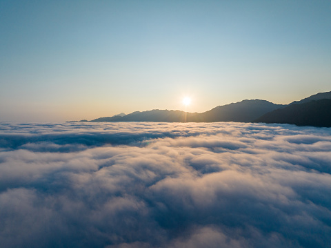 Sunrise over sea of clouds and valley