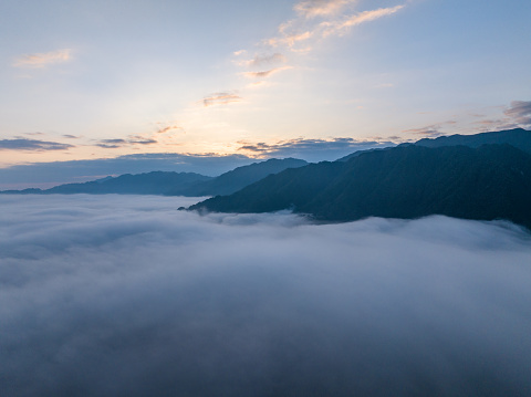 Sunrise over sea of clouds and valley