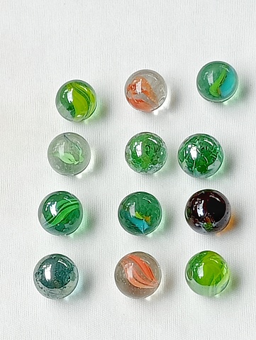 Marbles children toys from the 90s placed on a white background. Marbles are reflecting very beautiful.