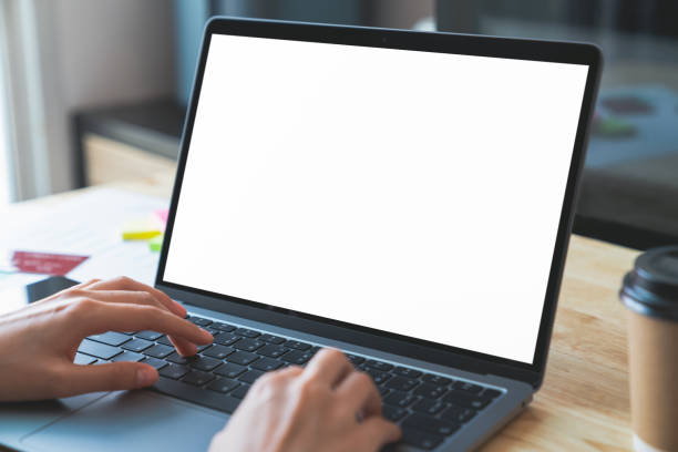 istock Businessman hand typing on laptop and working on computer on wooden table, screen blank mockup. 1709167927