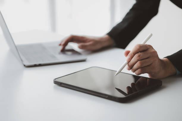 istock Businessman with a tablet, he uses the tablet to view business documents and communicate sending e-mail messages over the internet. The concept of using technology in communication. 1709249096