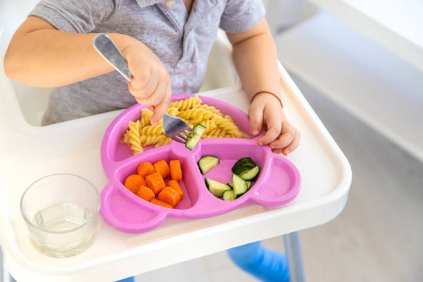 istock The child eats pasta and vegetables. Selective focus. 1709275222