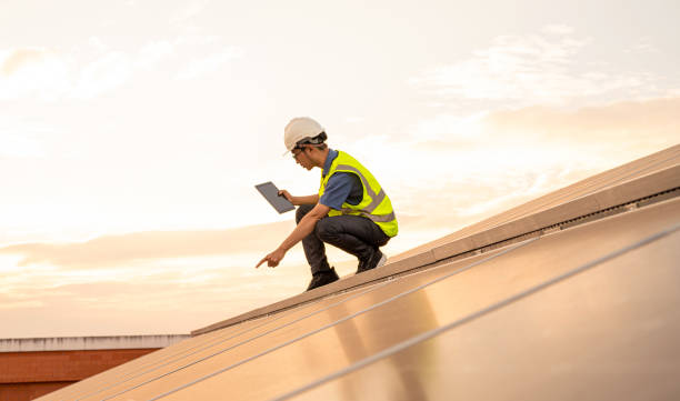 istock Service Engineer use tablet working inspection installation solar cell on the roof. 1709277971