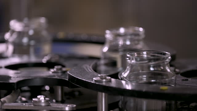 Glass jars on factory production line.