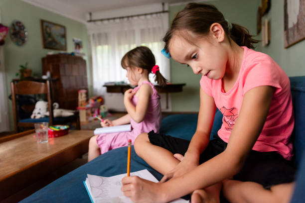 istock Children sitting on sofa and drawing at home 1709287631