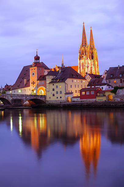 The Regensburg Clock Tower, the stone bridge and the Regensburg cathedral at dusk