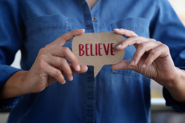 Woman holding speech bubble with believe word