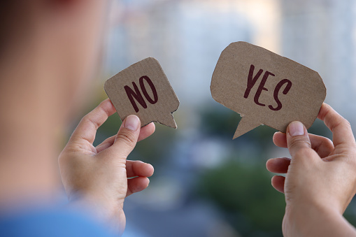 Woman holding speech bubble with Yes and No