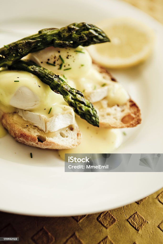 Eggs Benedicts Eggs benedicts with asparagus and brie cheese. Hollandaise Sauce Stock Photo