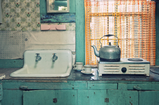 Tea is on inside an antique kitchen.  Cross processed.