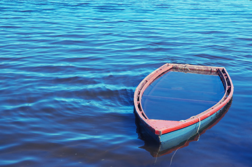 A sunken wooden rowboat.