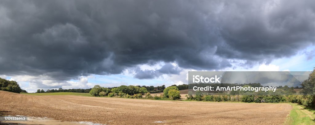 A storm is coming Surrey England Storm is coming dramatic sky near Guildford Surrey England Europe Agricultural Field Stock Photo