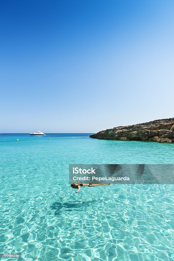 Idyllic and relaxing holidays Idyllic holidays: girl floating in fresh clean turquoise water. Beach Stock Photo