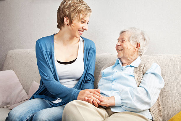 istock senior and young woman holding hands 170936935