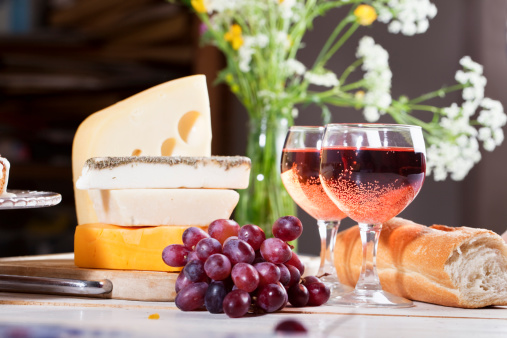 glasses of rose with grapes, bread and cheese