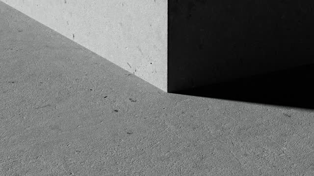 An up-close view of a concrete corner bathed in light.