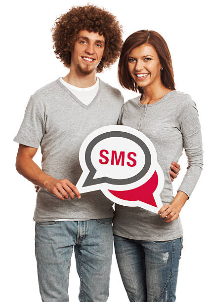 istock Smiling young couple holding SMS message sign isolated on white. 170939187