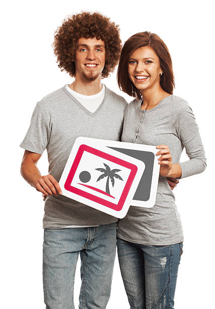 istock Smiling young couple holding image sign isolated on white background. 170939269