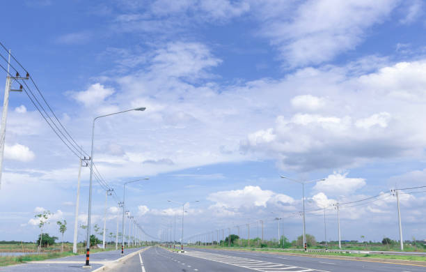 istock Asphalt highway road with concrete walkway with wide blue sky background. 1709435963