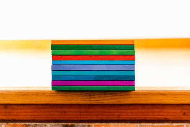 Several books stacked by their backs of different colors like rainbow, empty to fill with text.