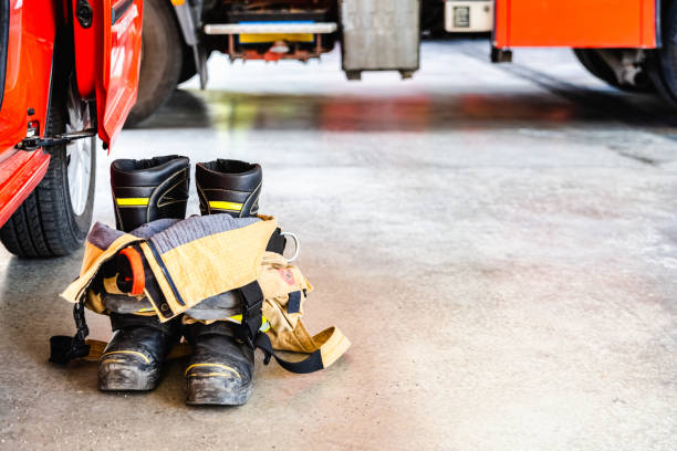 Flame retardant fireman's boots and pants ready to be used in case of emergency. Flame retardant fireman's boots and pants ready to be used in case of emergency. firefighter shield stock pictures, royalty-free photos & images