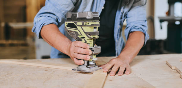 istock Carpenter works with wood in carpentry workshop. Man doing woodwork professionally 1709453245