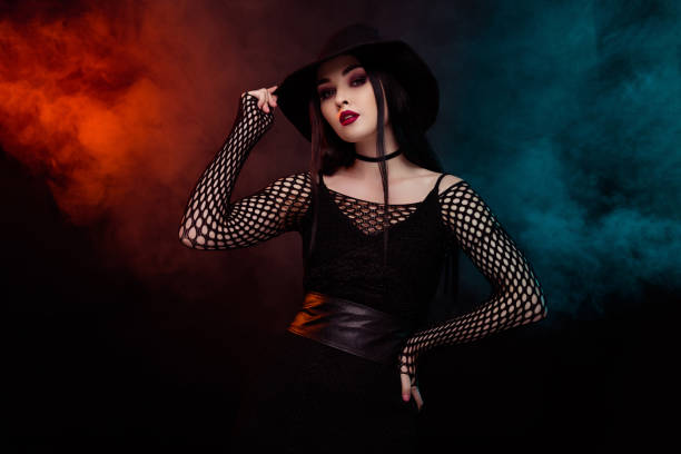 istock Photo of gorgeous stunning lady witch using black magic mystical spell over neon mist background 1709455564