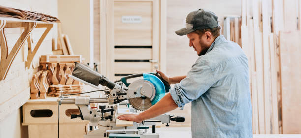 istock Carpenter works with wood in carpentry workshop. Man doing woodwork professionally 1709456080