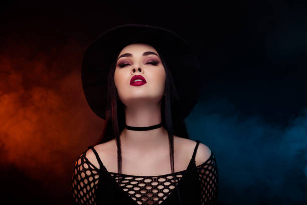 istock Stunning lady wizard bewitched with divination calling powerful demon speel on misty neon background halloween night 1709456611