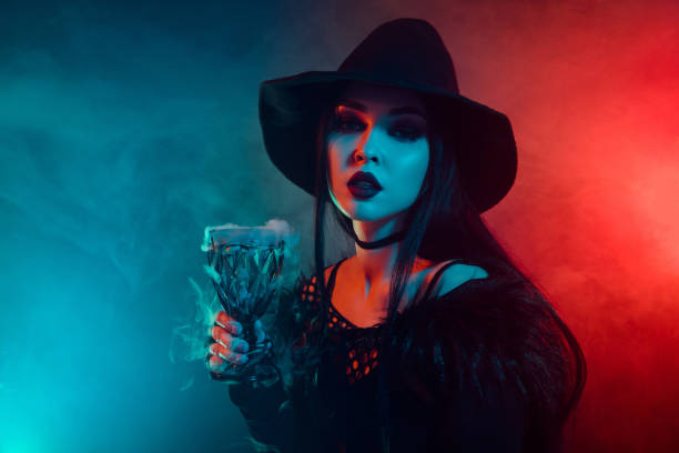 istock Photo of devil dark witch prepare spooky ritual poisonous elixir with mist over colorful neon background 1709462135