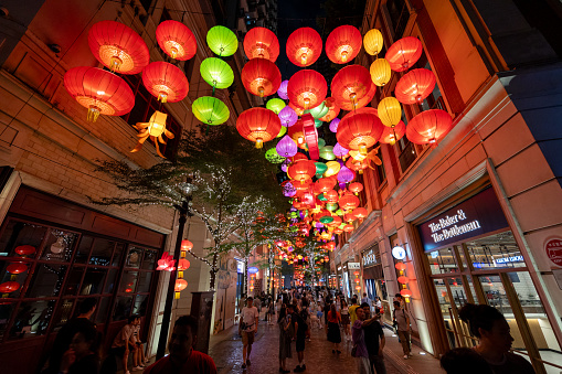 Hong Kong - September 29, 2023 : People walk under lanterns hanged from the ceiling at Lee Tung Avenue in Wan Chai, Hong Kong to celebrate the Mid-Autumn Festival.