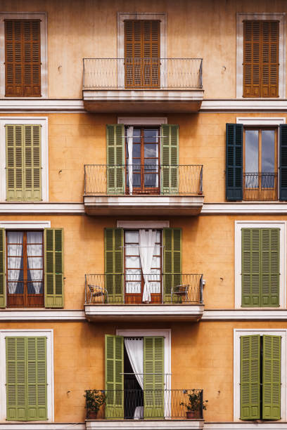 Facade with balcony and window blinds of traditional building in city street Palma, Mallorca