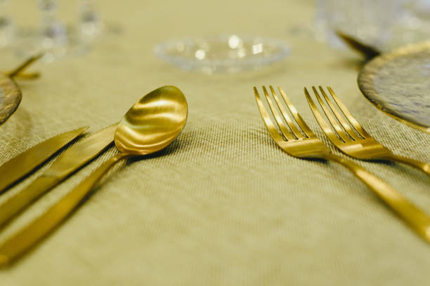 istock Luxury golden cutlery for special occasions such as Christmas on a table with a rustic tablecloth. 1709518377