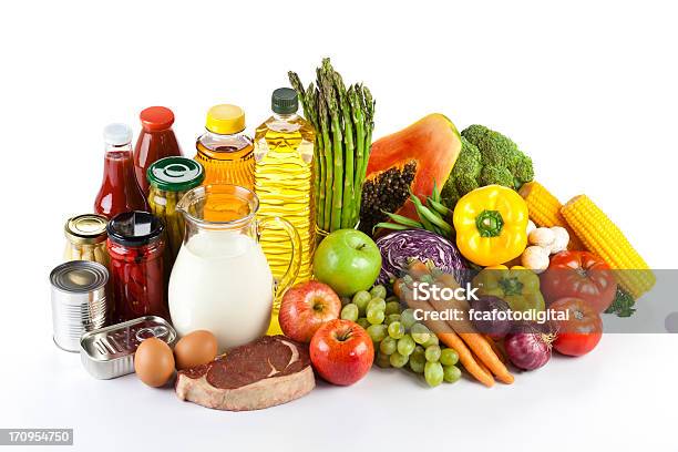 Large Group Of Groceries Arranged Neatly On White Table Stock Photo - Download Image Now