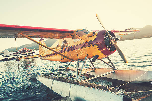 Float Planes in Sunset Float plane dock in Ketchikan, Alaska. bush plane stock pictures, royalty-free photos & images