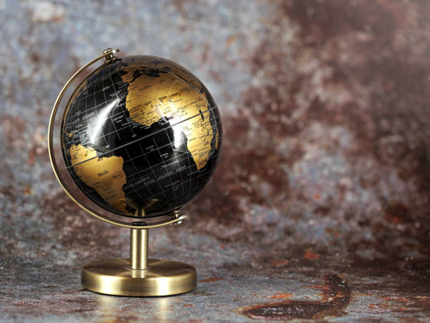istock gold-black world globe isolated on brown-gray background with copy space 1709565757