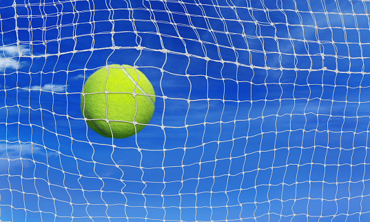 tennis ball into the net sky background